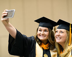 Graduates taking a selfie. Links to Gifts of Appreciated Securities